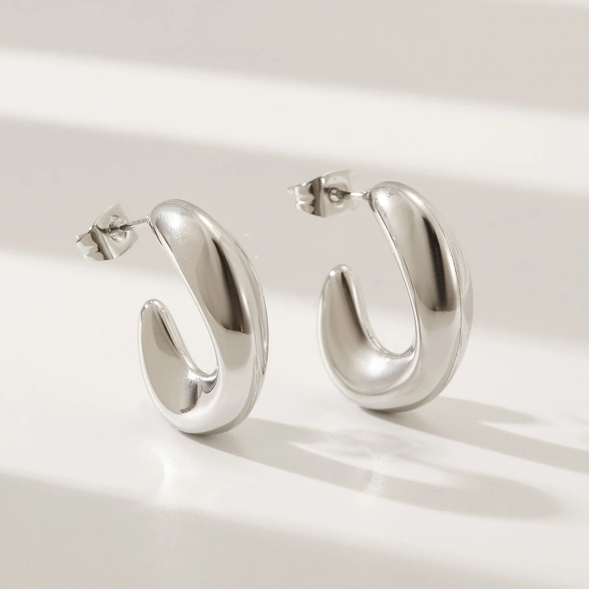 Bold Silver Crescent Hoop Earrings – Sleek & Modern